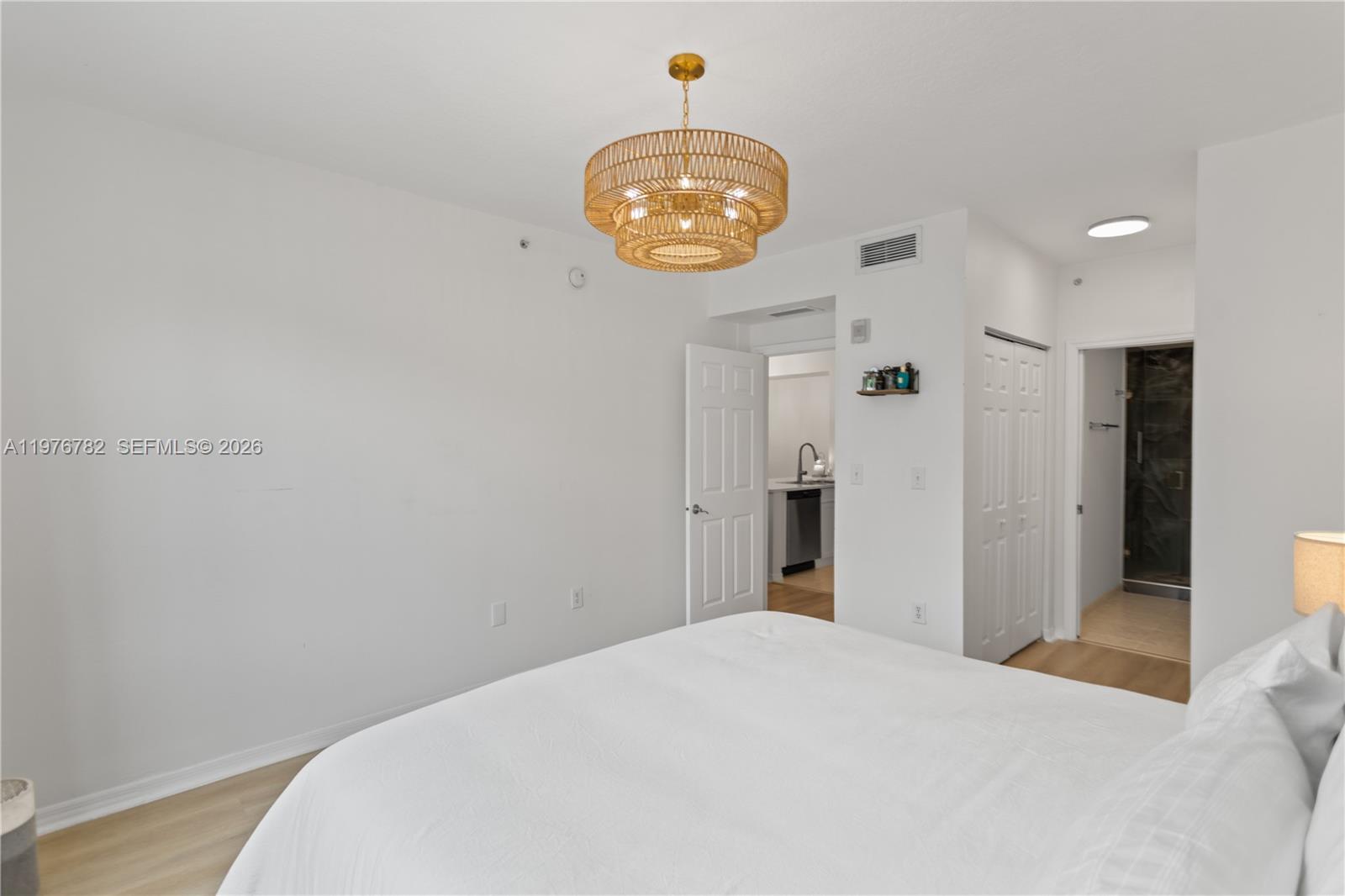 6851 Southwest 44th Street, Unit 107 Miami, FL 33155 - Photo 20 of 41 a bedroom with a bed and a chandelier