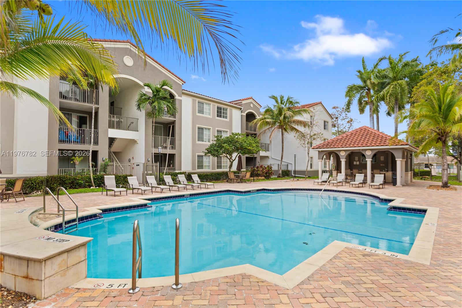 6851 Southwest 44th Street, Unit 107 Miami, FL 33155 - Photo 2 of 41 a view of a house with pool and chairs