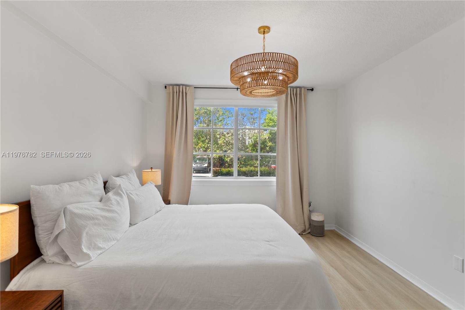 6851 Southwest 44th Street, Unit 107 Miami, FL 33155 - Photo 21 of 41 a bedroom with a bed and a chandelier