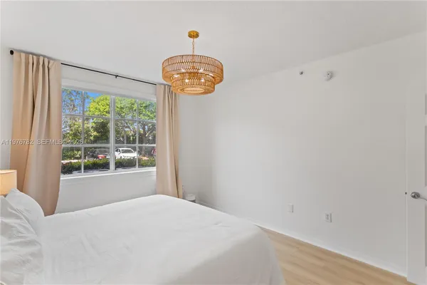 a bedroom with a bed and a chandelier