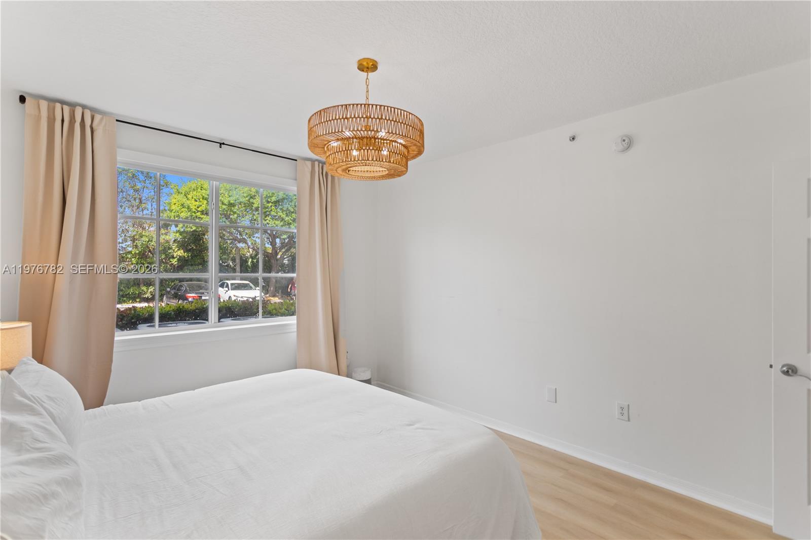 6851 Southwest 44th Street, Unit 107 Miami, FL 33155 - Photo 22 of 41 a bedroom with a bed and a window