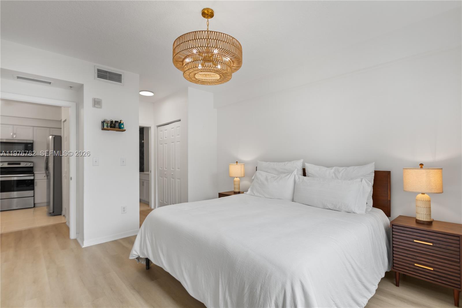 6851 Southwest 44th Street, Unit 107 Miami, FL 33155 - Photo 23 of 41 a bedroom with a bed and a chandelier