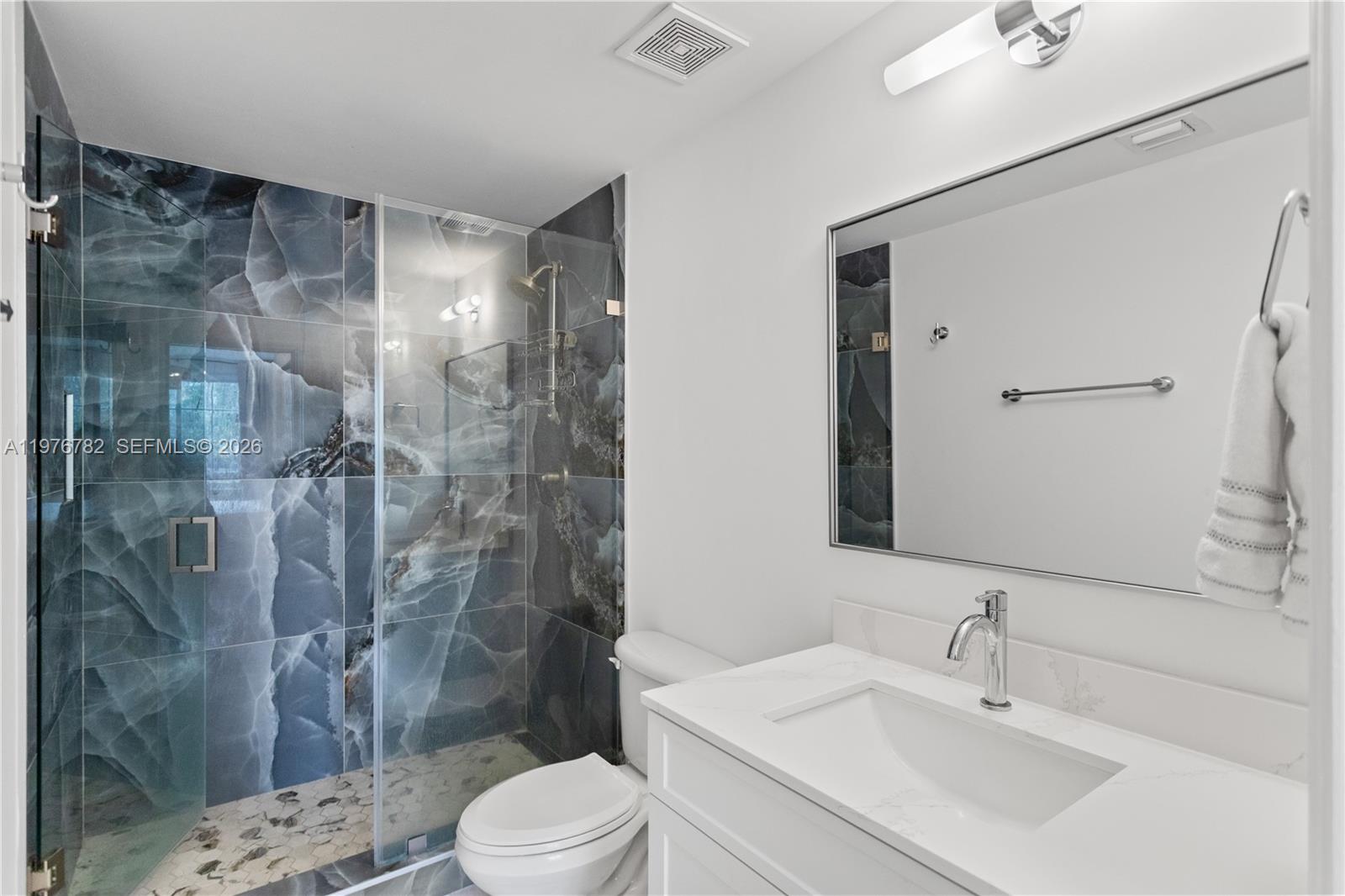 6851 Southwest 44th Street, Unit 107 Miami, FL 33155 - Photo 24 of 41 a bathroom with a sink mirror toilet and shower