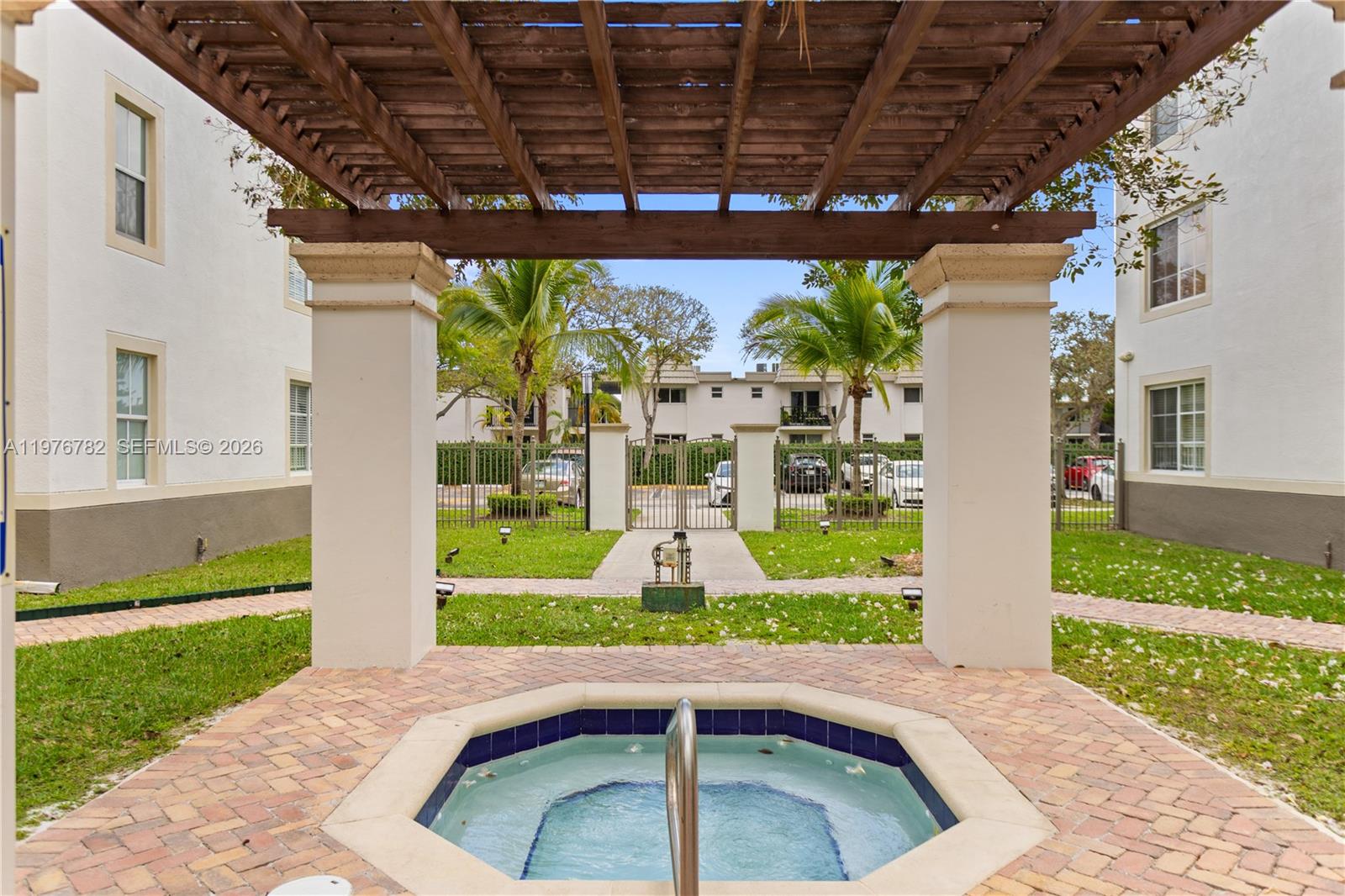 6851 Southwest 44th Street, Unit 107 Miami, FL 33155 - Photo 3 of 41 a front view of a house with a yard