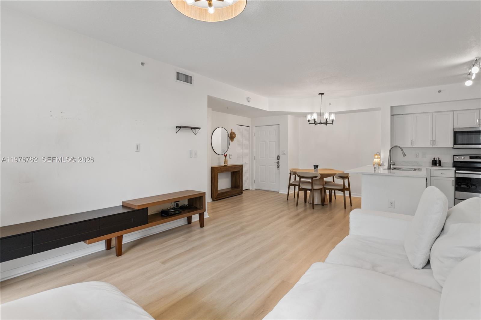 6851 Southwest 44th Street, Unit 107 Miami, FL 33155 - Photo 31 of 41 a living room with furniture and a table