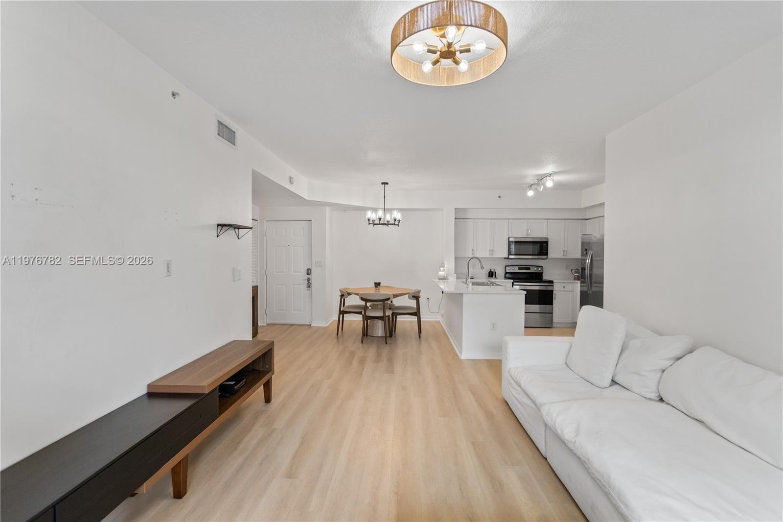 6851 Southwest 44th Street, Unit 107 Miami, FL 33155 - Photo 32 of 41 a living room with furniture and a wooden floor