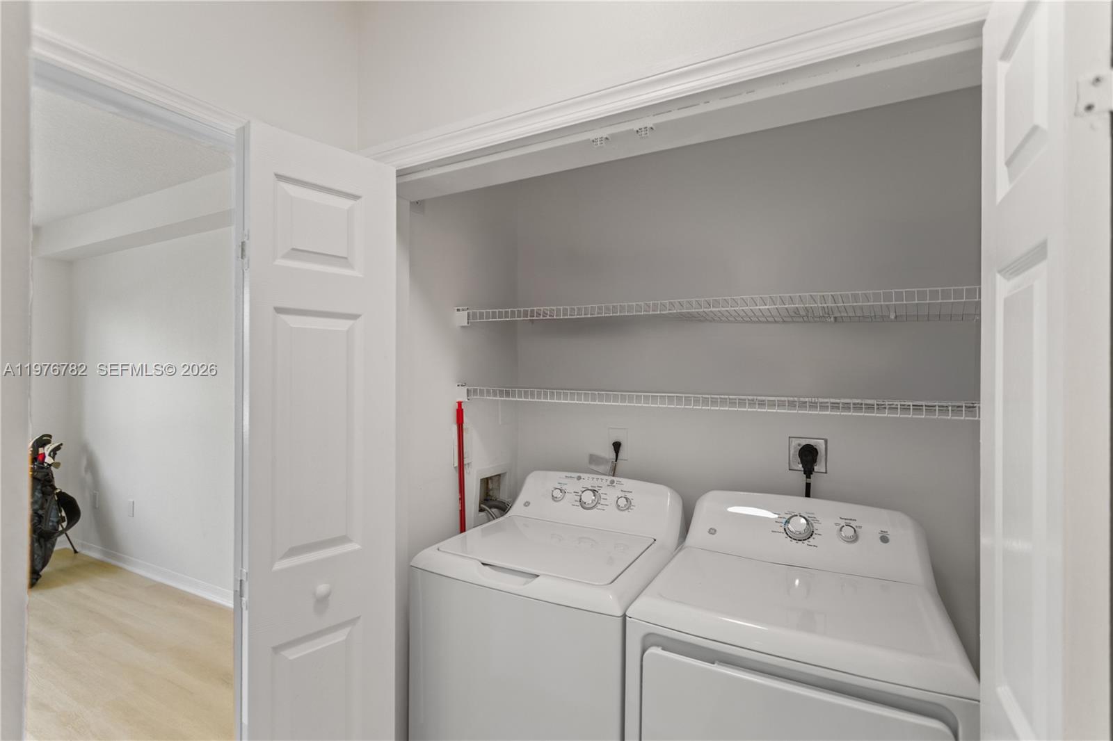 6851 Southwest 44th Street, Unit 107 Miami, FL 33155 - Photo 35 of 41 a view of storage and utility room with washer and dryer