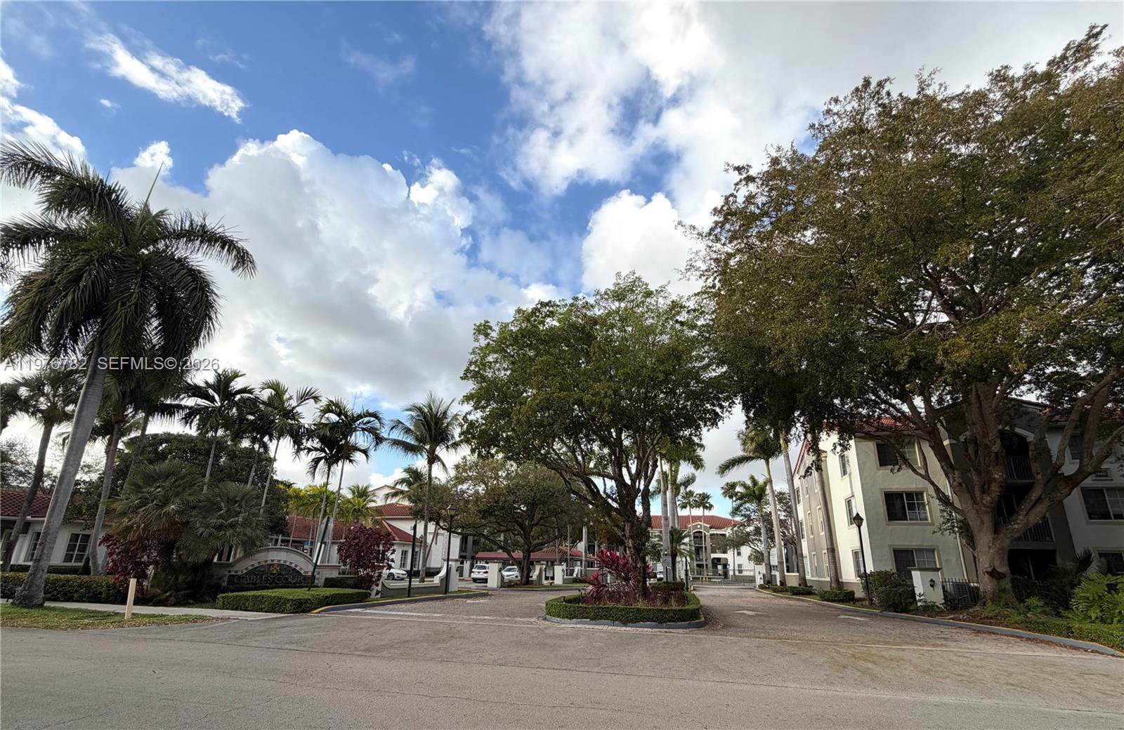 6851 Southwest 44th Street, Unit 107 Miami, FL 33155 - Photo 39 of 41 a city street lined with buildings and trees