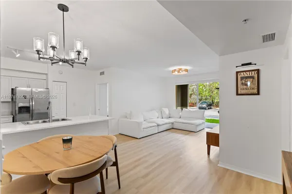 a living room with furniture and a chandelier