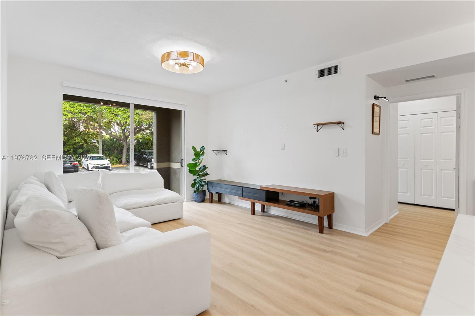 6851 Southwest 44th Street, Unit 107 Miami, FL 33155 - Photo 5 of 41 a living room with furniture and a window