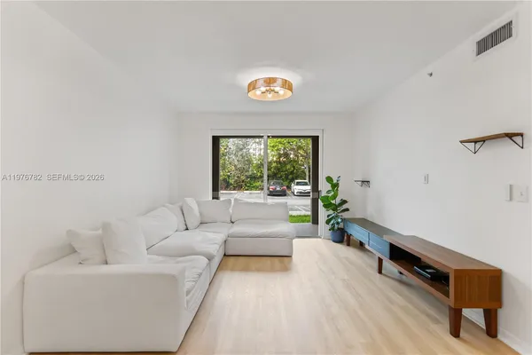 a living room with furniture and a window