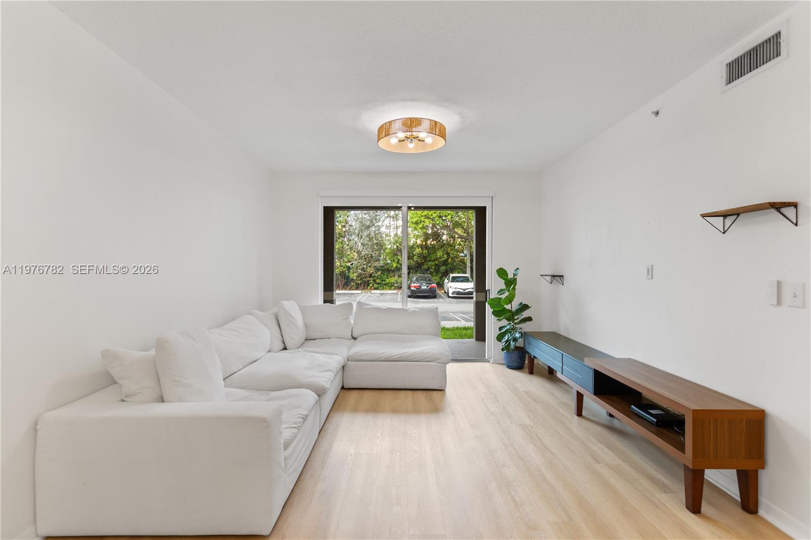 6851 Southwest 44th Street, Unit 107 Miami, FL 33155 - Photo 6 of 41 a living room with furniture and a window