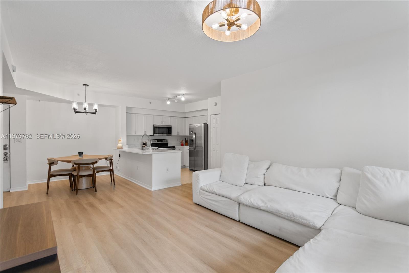 6851 Southwest 44th Street, Unit 107 Miami, FL 33155 - Photo 9 of 41 a living room with furniture kitchen view and a dining table