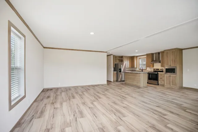 a view of kitchen with microwave and cabinets