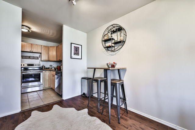 1030 North State Street, Unit 20D Chicago, IL 60610 - Photo 12 of 22 a view of a kitchen with fridge and wooden floor