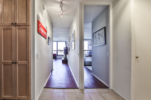 1030 North State Street, Unit 20D Chicago, IL 60610 - Photo 14 of 22 a view of a hallway with wooden floor and staircase