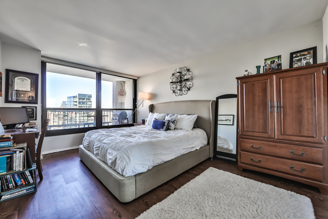 1030 North State Street, Unit 20D Chicago, IL 60610 - Photo 15 of 22 a bedroom with a bed dresser and a large window