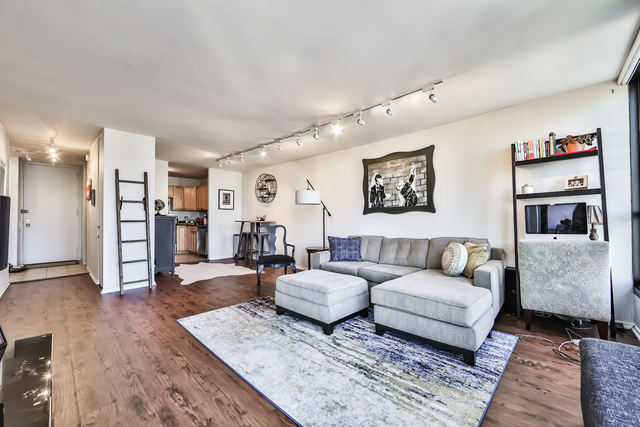 1030 North State Street, Unit 20D Chicago, IL 60610 - Photo 3 of 22 a living room with furniture and wooden floor