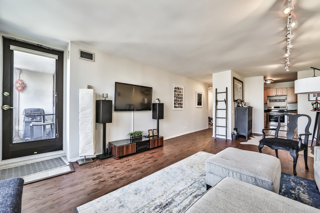 1030 North State Street, Unit 20D Chicago, IL 60610 - Photo 4 of 22 a living room with furniture and a flat screen tv