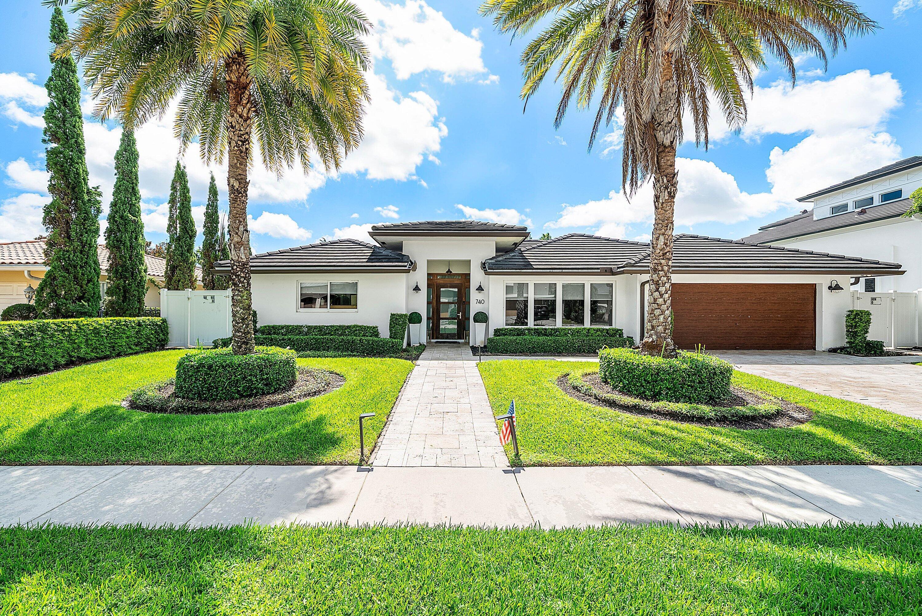 740 Northeast 36th Street Boca Raton, FL 33431 - Photo 1 of 43 a view of a house with a yard and potted plants