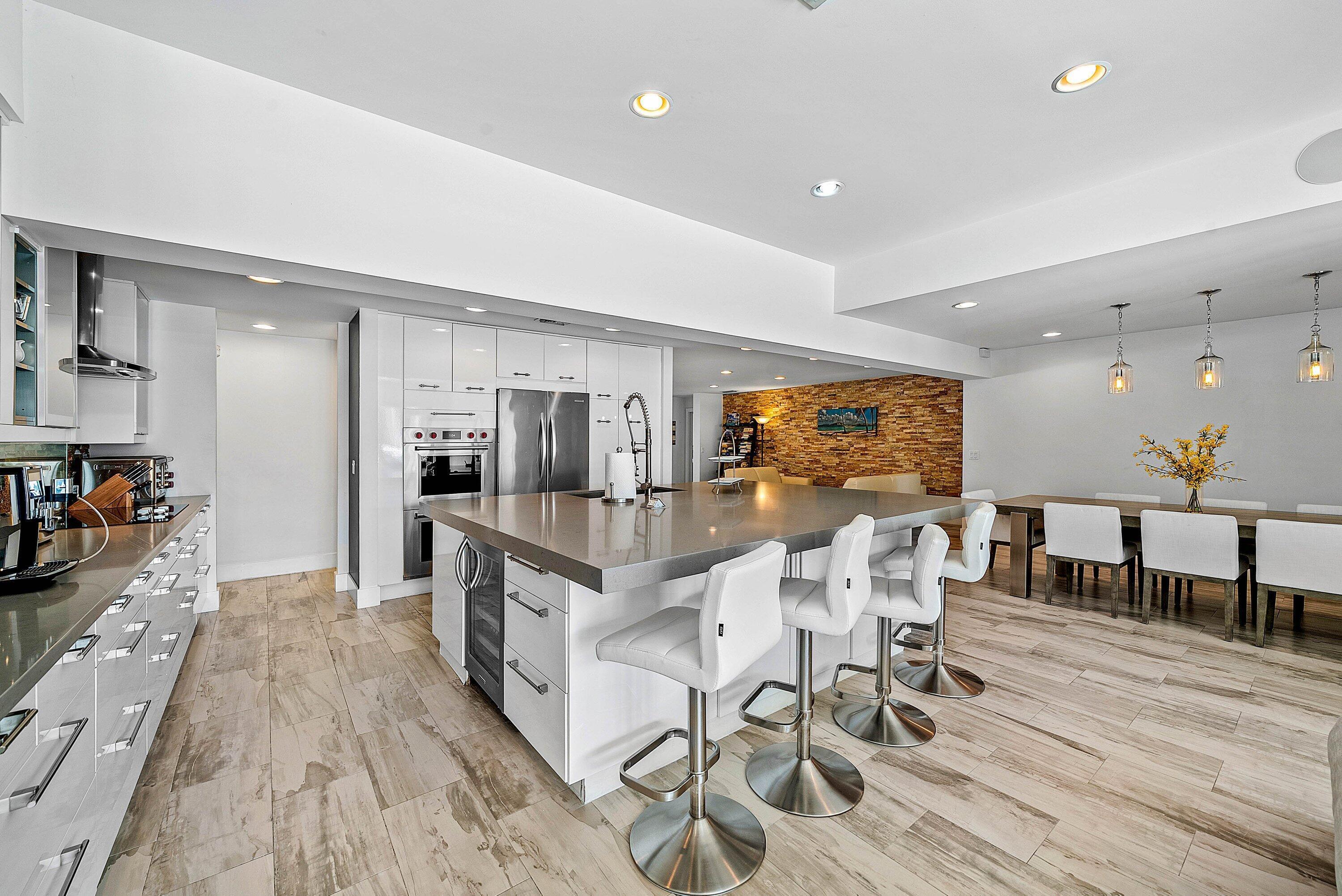 740 Northeast 36th Street Boca Raton, FL 33431 - Photo 11 of 43 a view of a dining room kitchen with furniture wooden floor and chandelier