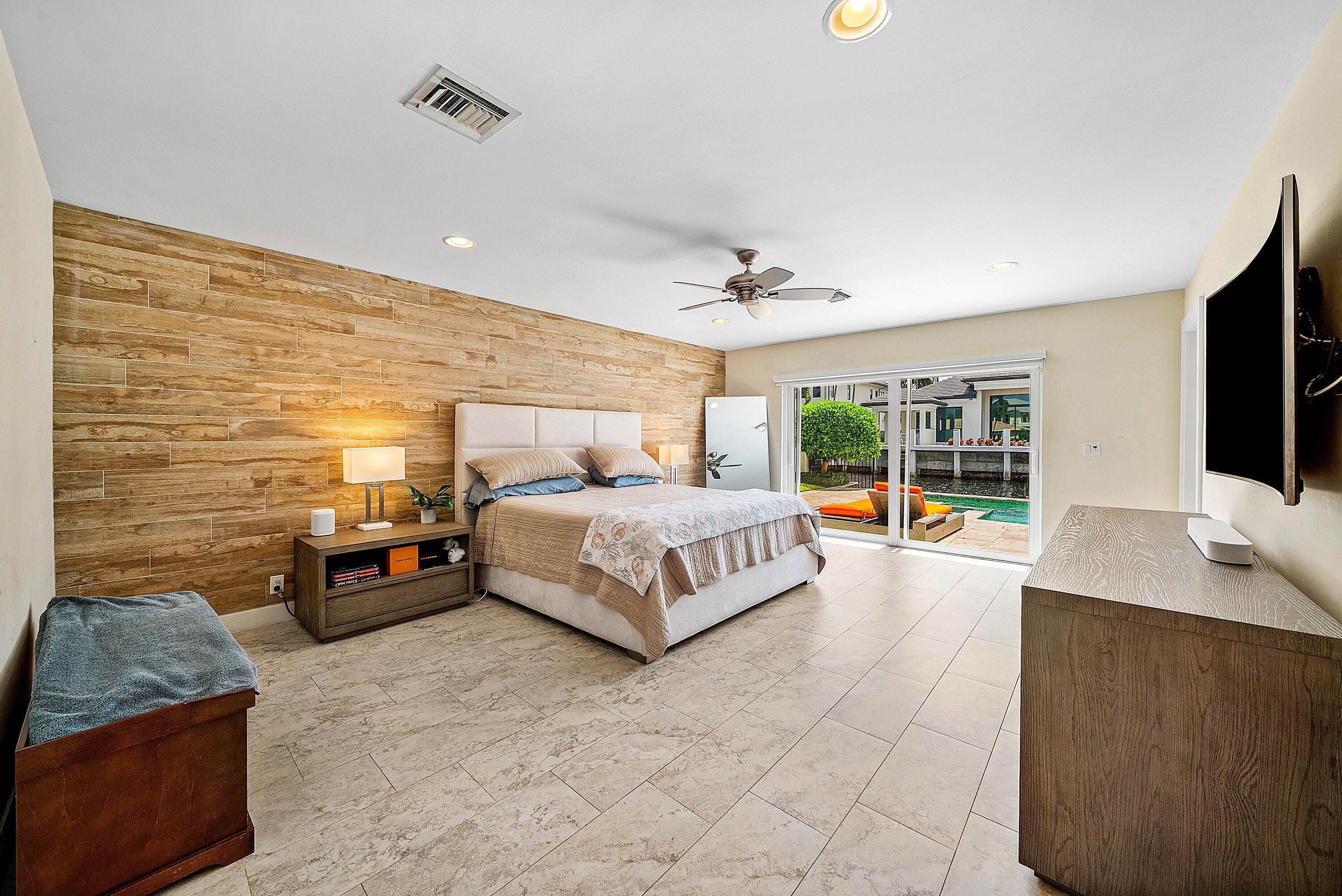740 Northeast 36th Street Boca Raton, FL 33431 - Photo 14 of 43 a bedroom with a bed and a flat screen television