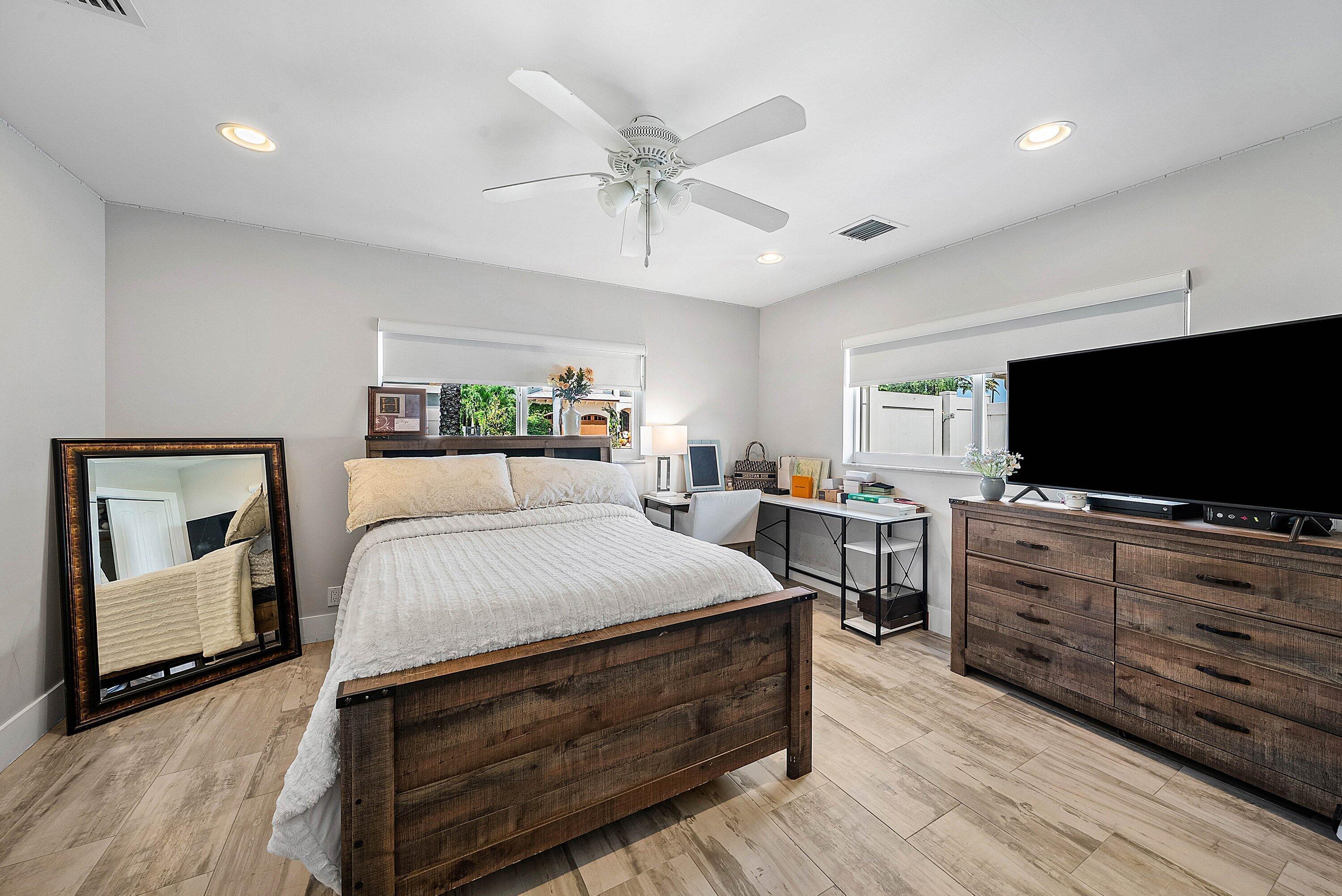 740 Northeast 36th Street Boca Raton, FL 33431 - Photo 17 of 43 a bed room with furniture and a flat screen tv