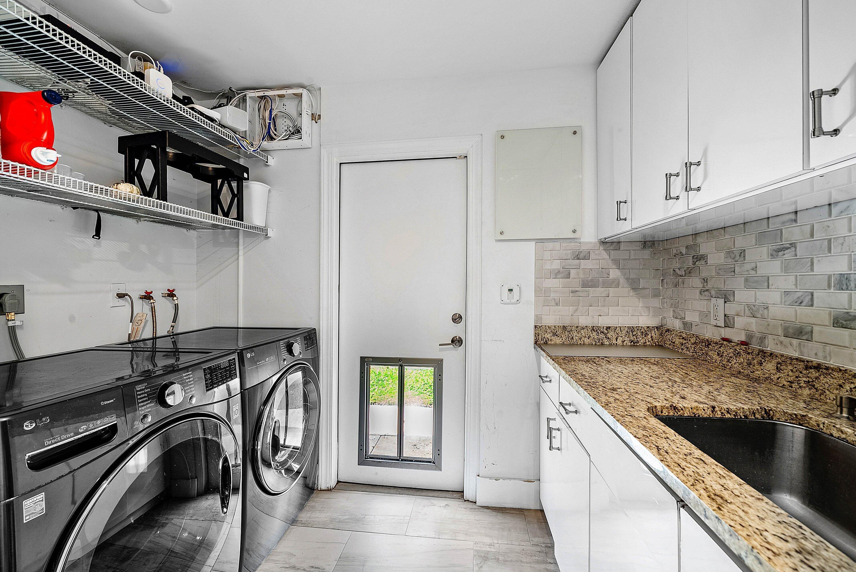 740 Northeast 36th Street Boca Raton, FL 33431 - Photo 18 of 43 a view of a kitchen with washer and dryer