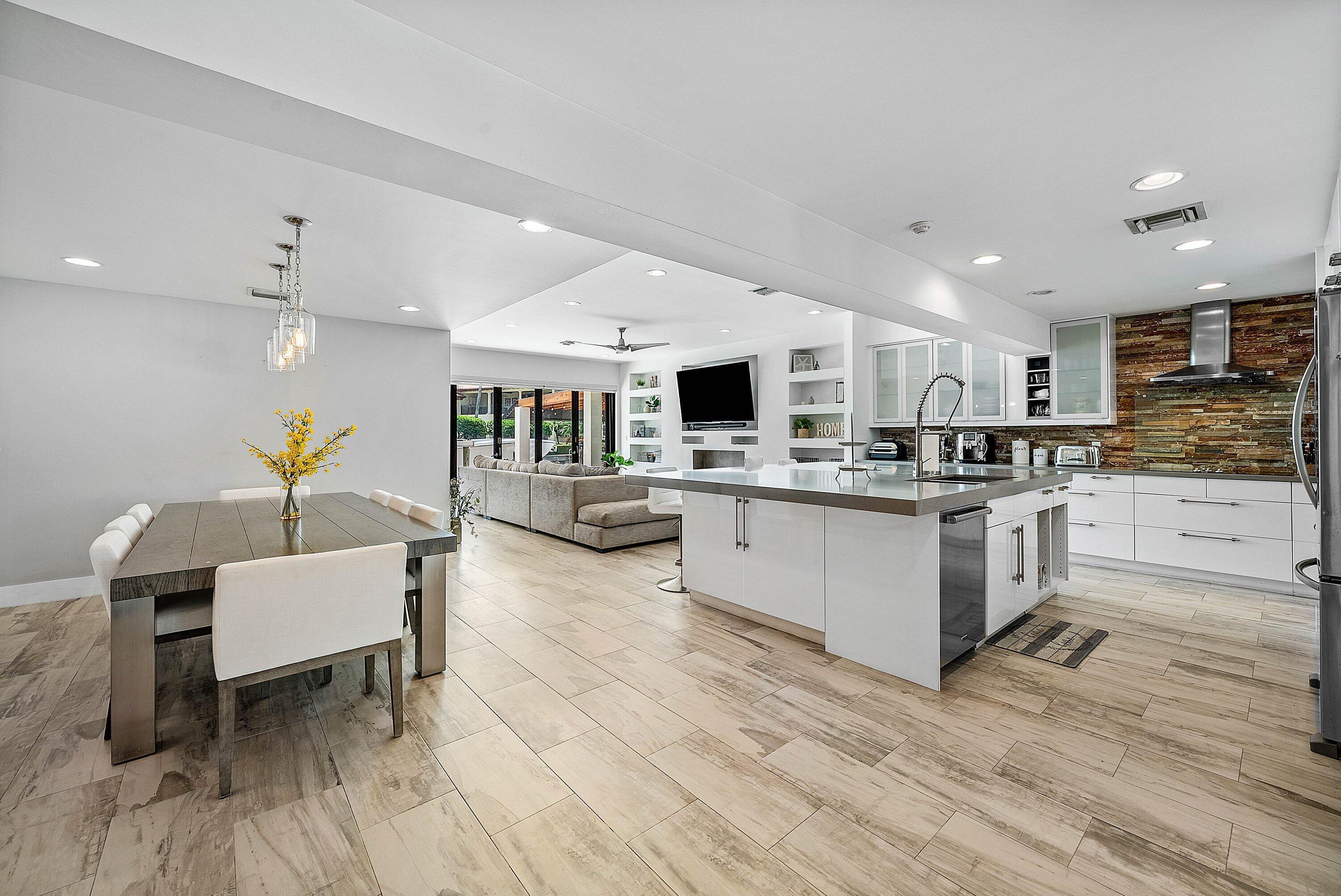 740 Northeast 36th Street Boca Raton, FL 33431 - Photo 6 of 43 a kitchen with a table chairs refrigerator and microwave