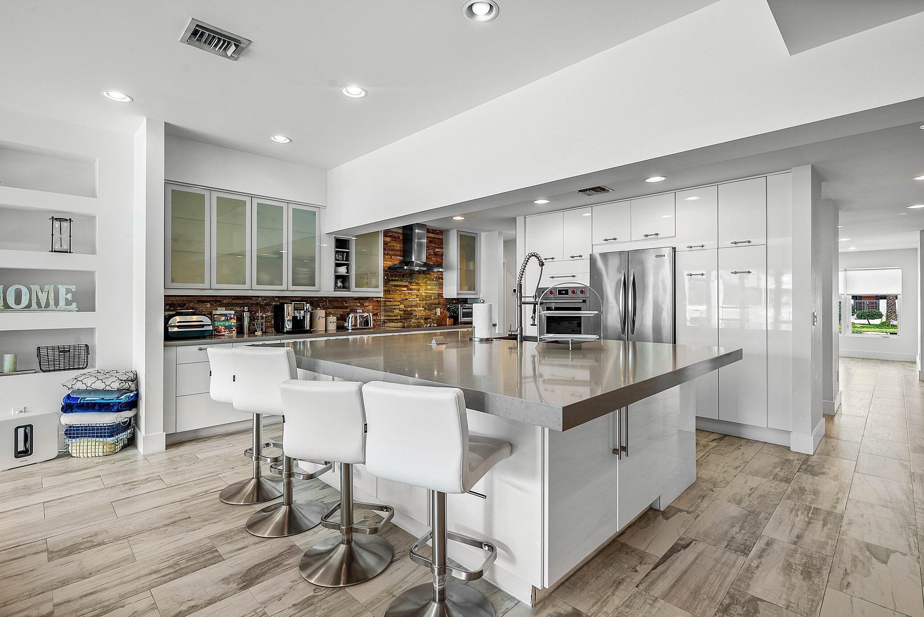 740 Northeast 36th Street Boca Raton, FL 33431 - Photo 7 of 43 a kitchen with stainless steel appliances granite countertop a stove refrigerator and a sink