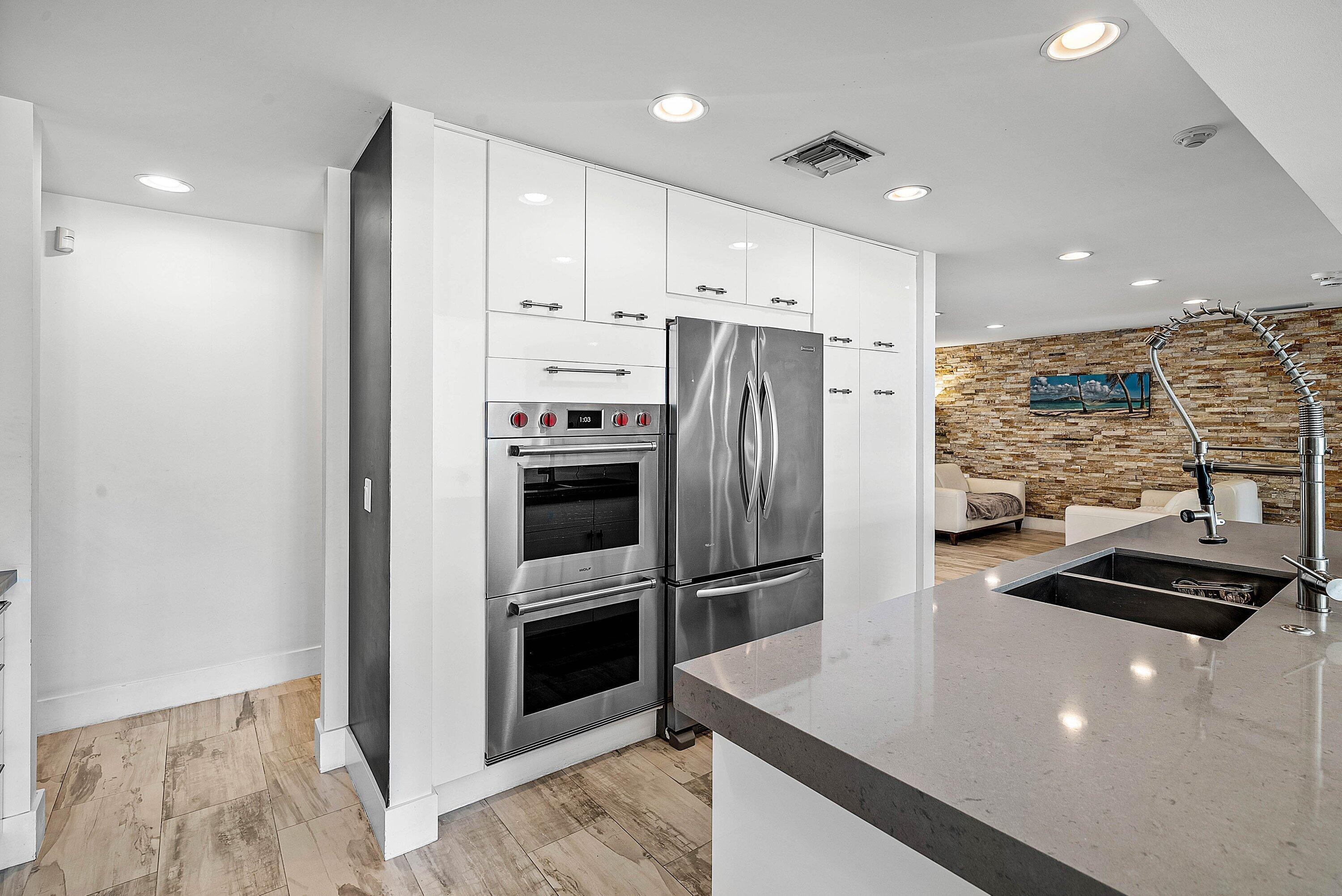 740 Northeast 36th Street Boca Raton, FL 33431 - Photo 10 of 43 a kitchen with stainless steel appliances granite countertop a refrigerator and a stove