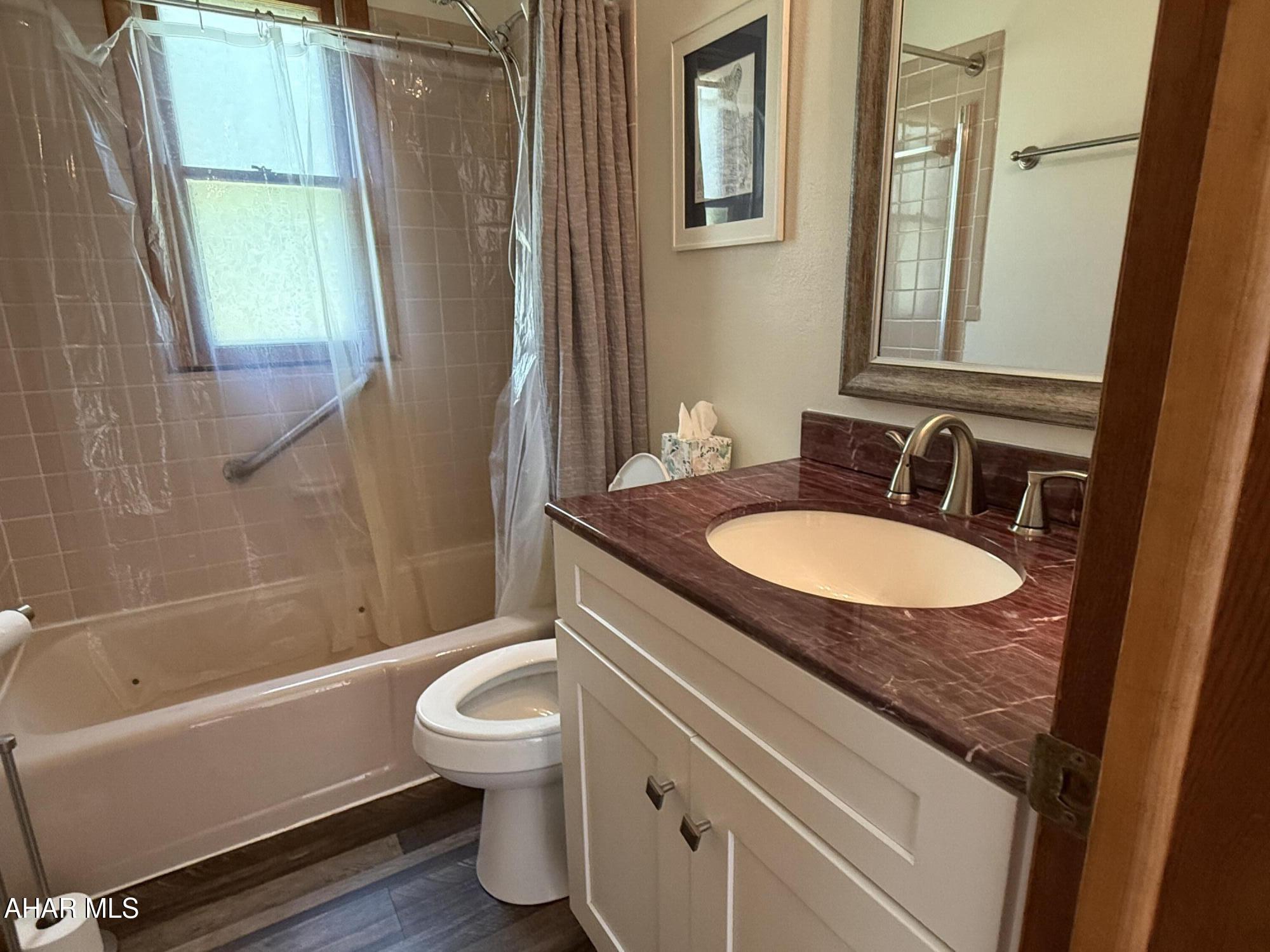 473 Calhoun Road Everett, PA 15537 - Photo 22 of 45 a bathroom with a sink toilet a mirror and a tub
