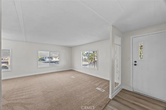 an empty room with windows and closet