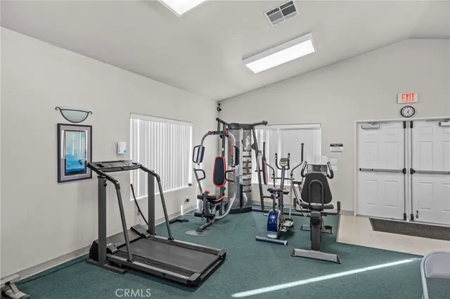 a living room with furniture a ceiling fan and a window