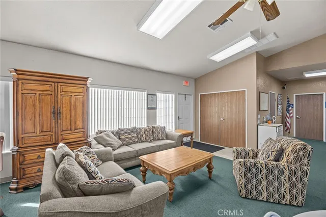 a kitchen with a refrigerator and white cabinets
