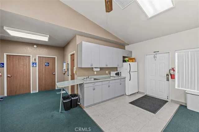 a room with gym equipment pool table and windows