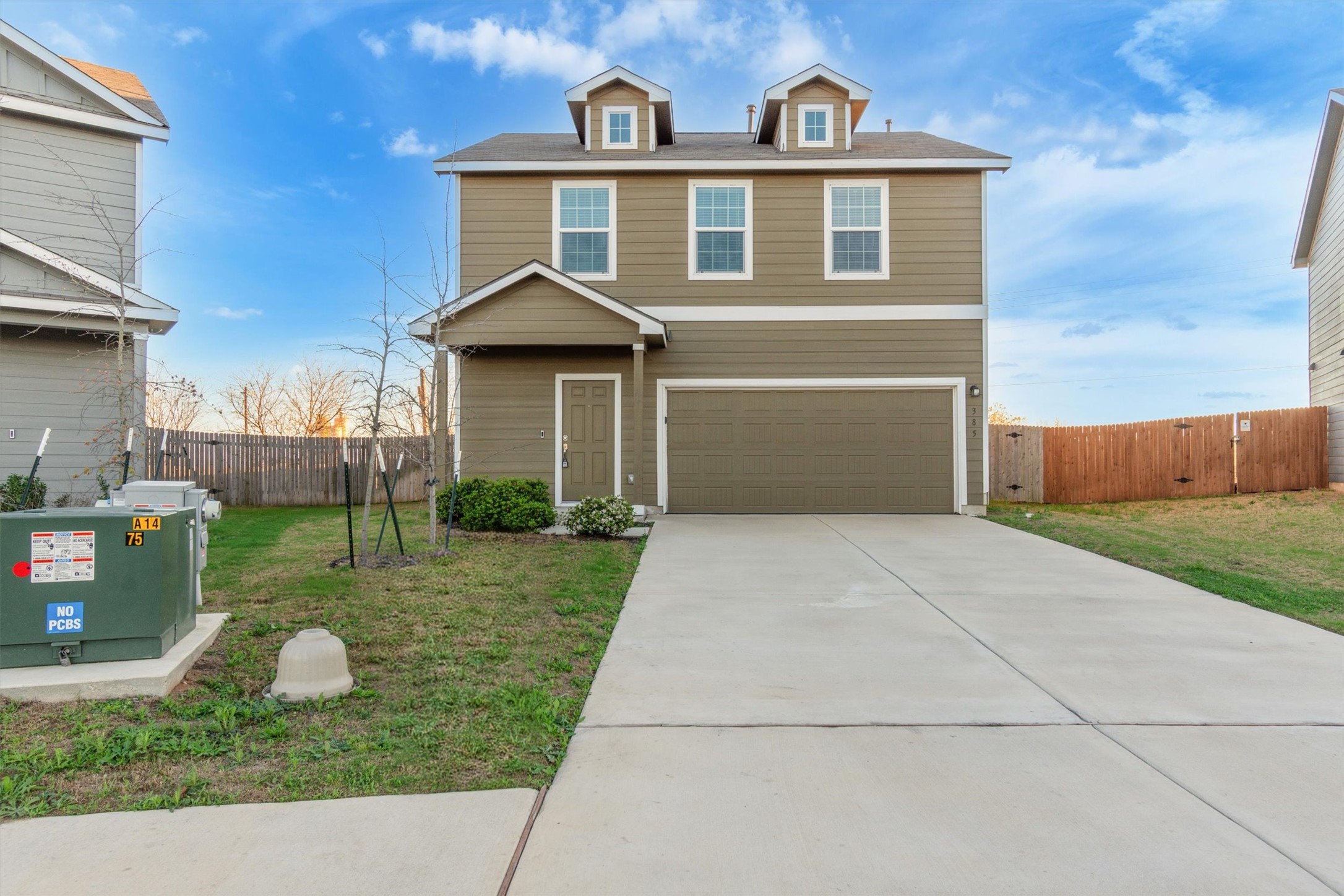 385 Soapstone Pass Maxwell, TX 78656 - Photo 1 of 1 View of front facade with driveway, a garage, and a gate