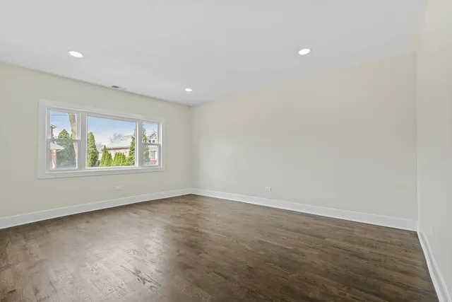 a kitchen with stainless steel appliances granite countertop a refrigerator sink and white cabinets