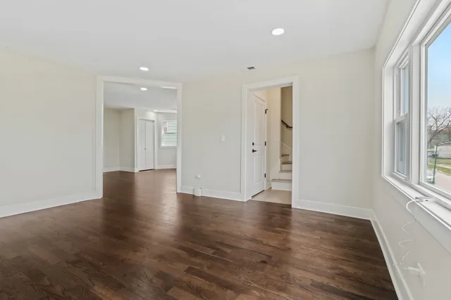 a kitchen with white cabinets and appliances