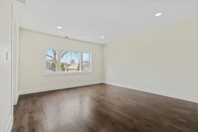 a view of an empty room with a kitchen