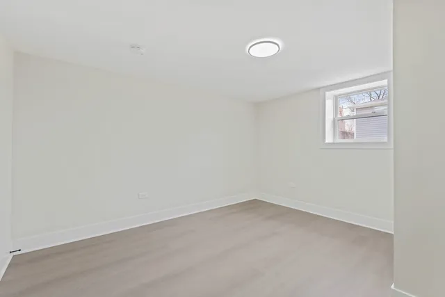 a kitchen with stainless steel appliances granite countertop white cabinets a sink a stove a microwave and cabinetry