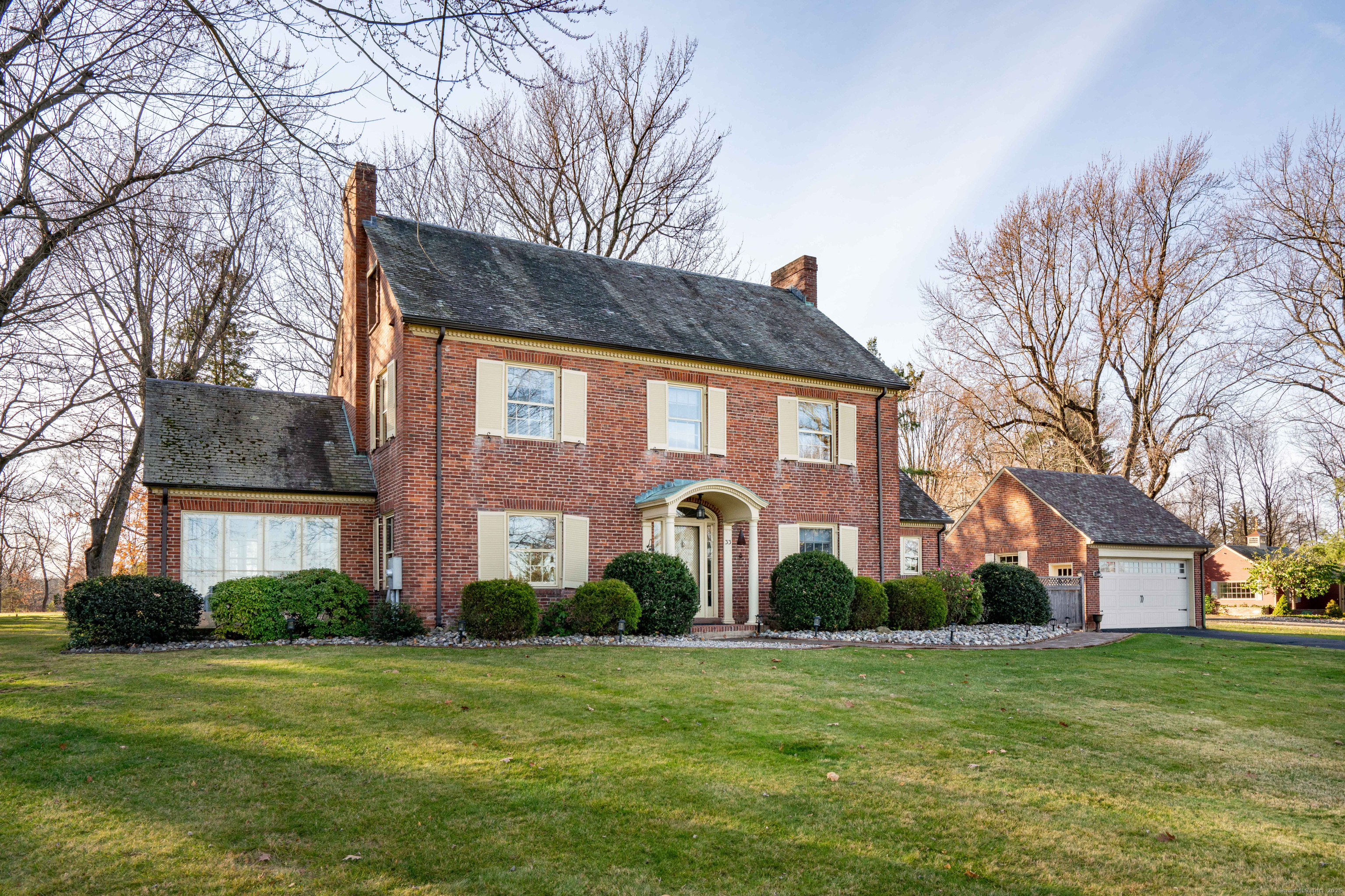a front view of house with a garden