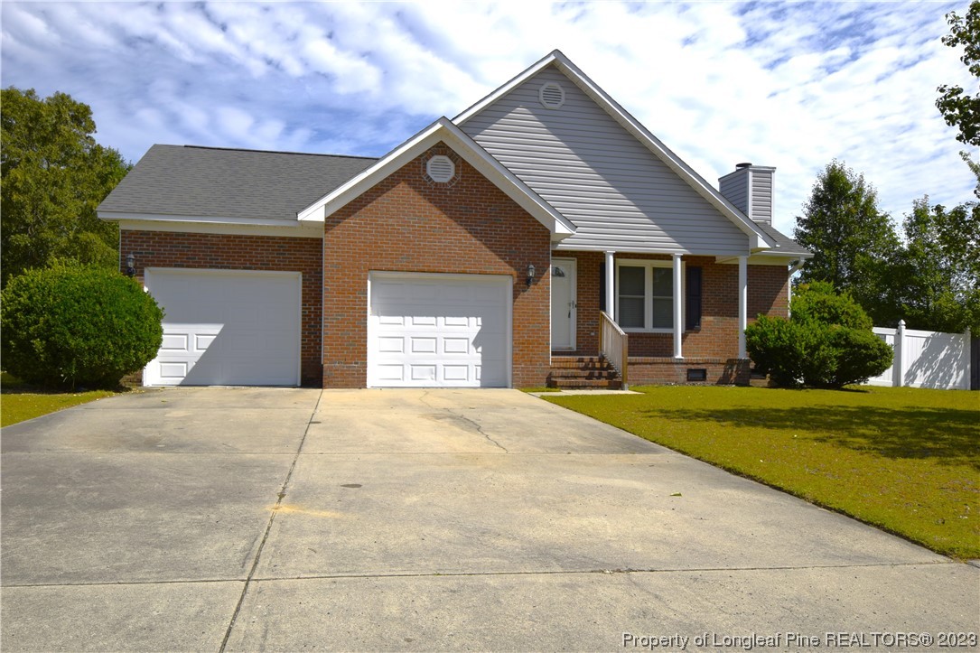 512 Kernstown Road Raeford, NC 28376 - Photo 1 of 25 a front view of a house with a yard and garage