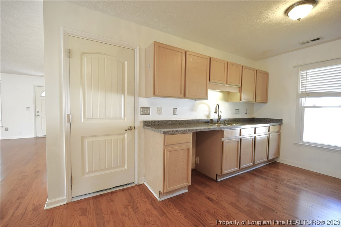 512 Kernstown Road Raeford, NC 28376 - Photo 11 of 25 a kitchen with granite countertop white cabinets and white appliances