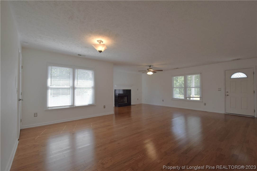 512 Kernstown Road Raeford, NC 28376 - Photo 5 of 25 an empty room with wooden floor and windows