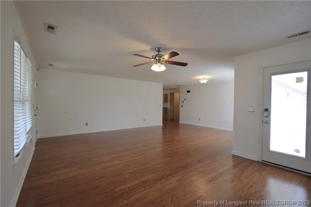 512 Kernstown Road Raeford, NC 28376 - Photo 7 of 25 an empty room with wooden floor and ceiling fan