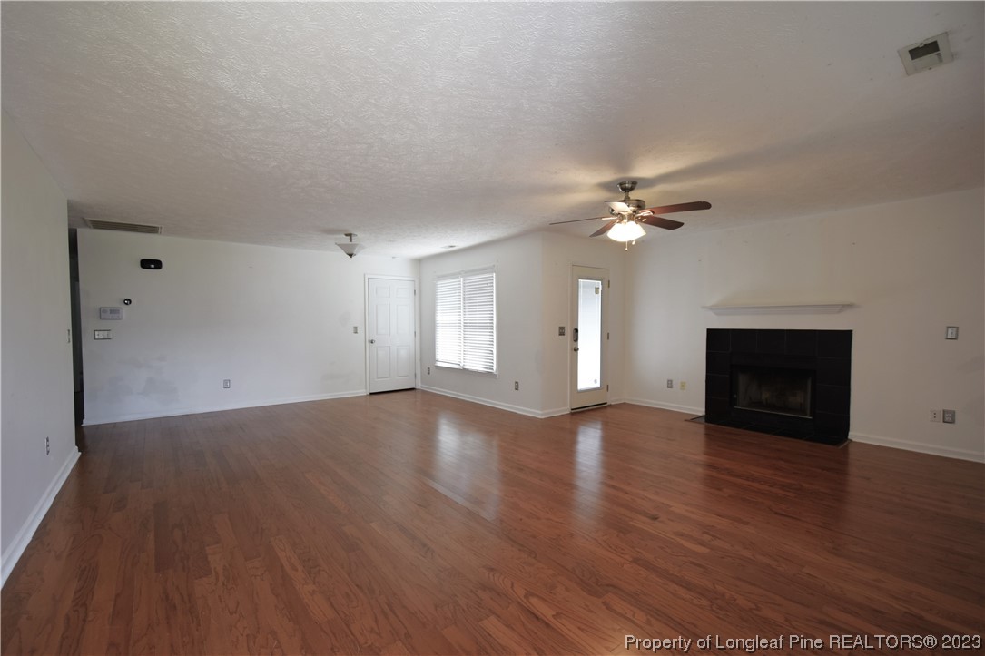 512 Kernstown Road Raeford, NC 28376 - Photo 8 of 25 a view of an empty room with wooden floor and a fireplace