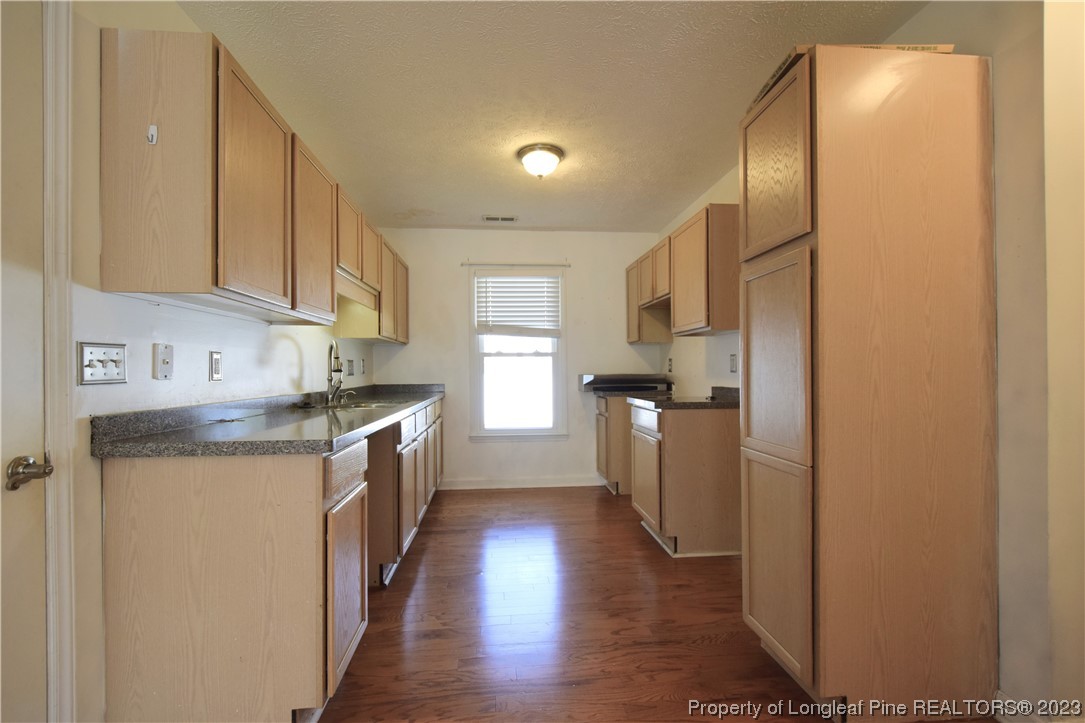 512 Kernstown Road Raeford, NC 28376 - Photo 10 of 25 a kitchen with a sink a counter top space stainless steel appliances and cabinets