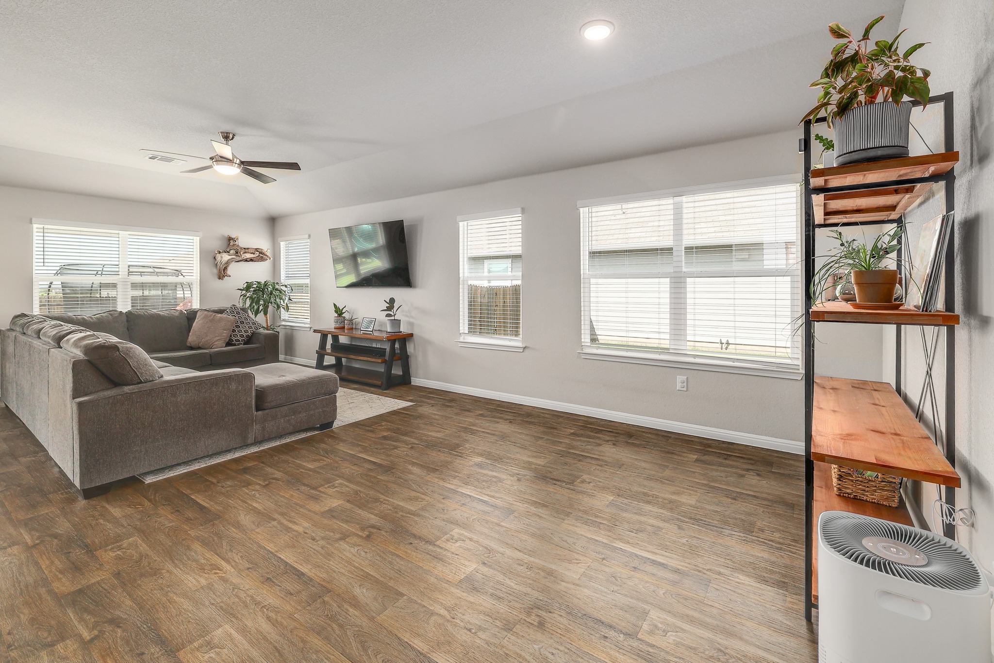 413 Hunter Loop Bertram, TX 78605 - Photo 9 of 27 Bright breakfast nook and living area with a comfortable open flow, highlighted by multiple windows that fill the space with natural light and create an airy, welcoming feel.
