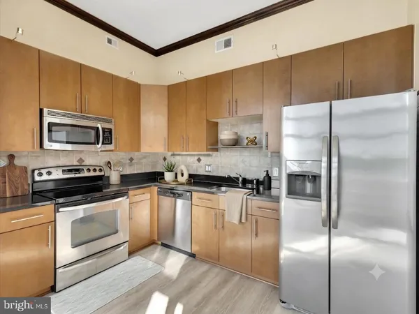 a kitchen with a refrigerator stove and microwave